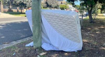 A discarded old mattress on a nature strip in Australia