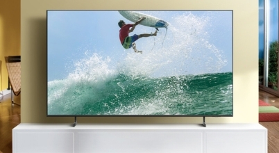 A Samsung Crystal TV mounted on a cabinet